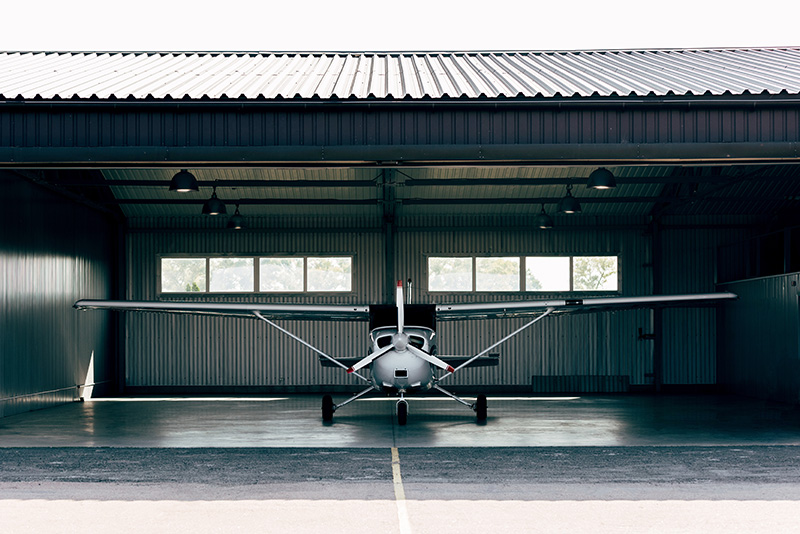 Small insured airplane in hanger